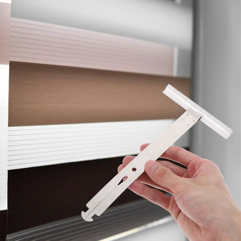Four Piece Heavy Gauge Roller Shutter Spring Replacement Kit Built From Top Shelf Stainless Steel For Easy Peasy Window Shutter Repairs And Reliable Daily Performance - hand holding tool against window shades.