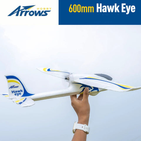 Person holding Arrows RC Plane 600mm Hawk Eyes Remote Control Airplane Ready to Fly RTF, white with blue and yellow accents