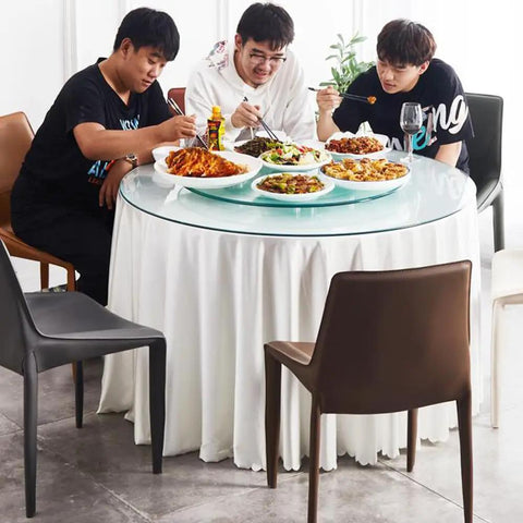 Extra Large Clear Glass Lazy Susan Turntable on a dining table with friends enjoying a variety of dishes.