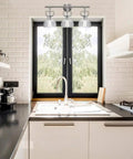 Kitchen scene with a window framed by a 3-light fixture, illustrating lighting style from the All In One Bathroom Vanity Set With A 3 Light Fixture.