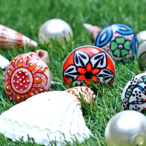 Top Tier Set Of 12 Handmade Ceramic Cabinet Knobs With Hella Smooth Drawer Pulls For Kitchen Bathroom Or Office Heavy Duty Rust Free Furniture Hardware Featuring Bold Multicolor Design displayed on grass with seashells.