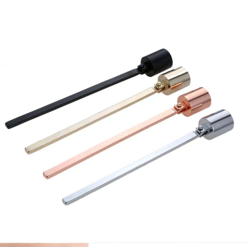 Four candle snuffers in black, gold, rose gold, and silver with long handles and straight tubes for tea lights and votive candles.
