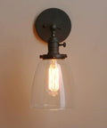 Vintage Industrial Wall Sconce With On Off Switch And Clear Glass Shade Indoor Vanity Light For Bathroom Bedroom Hallway Cafe Club Garage Classic Retro Glow For LED Incandescent Compatibility, single bulb lit against wall.