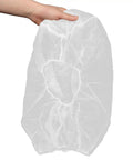 50 Pack White Disposable Nonwoven Space Hood Caps For Snagging Hair Tight, held in hand, showcasing durable head cover design.