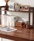 Open Style Wooden Bookshelf With Large Capacity Freestanding Storage Organizer displaying books and decor on a desk