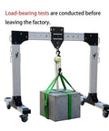 Heavy Duty Portable Aluminum Gantry Crane Kickin Out A Badass 4409 Pound Lift Capacity With Adjustable Beam Height showing load test with concrete block.