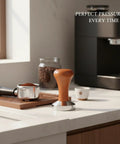 Top Shelf Espresso Coffee Tamper With Polished Stainless Steel Base And Sturdy Wooden Grip on a kitchen countertop.