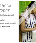 Woman using high-performance carbonless paper in a busy office, highlighting benefits and features such as NatureSolv technology.