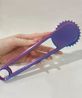 Slick Center Punch Tool With Ergonomic Grip For Dead Center Hole Marking And Quick Cardstock Punching Abs Plastic Build shown in purple color held in hand.
