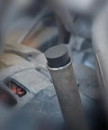 Smoke Machine Cap Plugs Kit 9 Piece Set For Leak Tests No Fuss Rubber Plugs sealing a round automotive pipe opening.