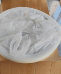 50 Inch Marble Lazy Susan Silent Rotating Serving Tray wrapped in protective film on a wooden surface.