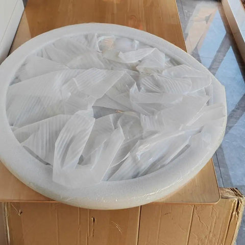 50 Inch Marble Lazy Susan Silent Rotating Serving Tray wrapped in protective film on a wooden surface.