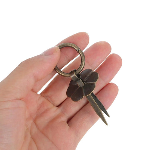 Hand holding a metal flower-shaped piece with ring; Vintage Style Retro Cabinet Drawer Pull Handles Set 15 Pieces