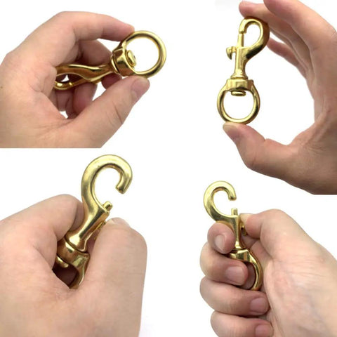 Top Shelf Heavy Duty Brass Flag Clips 4 Pack Swivel Snap Hooks For Rope Flagpole Attachment Built Tough showing brass hooks in hand.