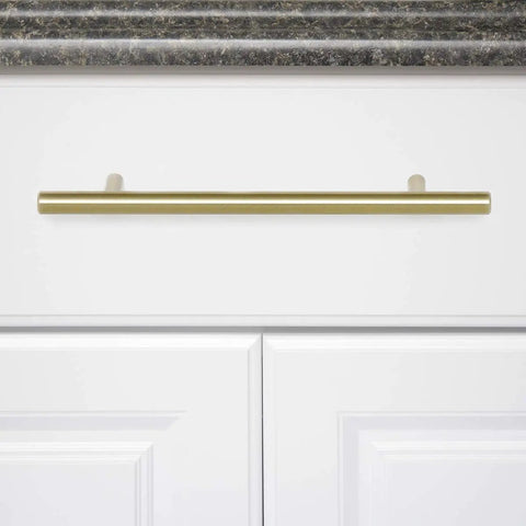 Golden Champagne Euro Bar Cabinet Handle 3/8 Inch Diameter 7-3/8 Inch Length 5 Inch Hole Center mounted on white cabinet