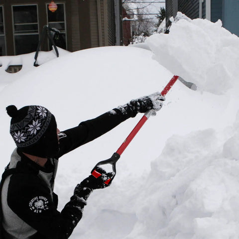 Man using 2 Pack Red D Grip Shovel Handles For 1-1/4 Inch Shovels, Plastic Replacement Grips With 32mm Inner Diameter, Easy Screw-On Install For Digging And Raking Tools on snowy day.