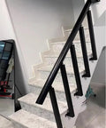 Rock Solid Adjustable 270 Degree Black Wrought Iron Railing Posts Side Mount Bracket 33.5 Inch Tall on stairway with white marble steps.