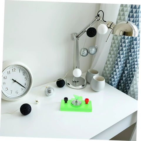 Desk with lamp, clock, cups, and Solar Powered DC Motor DIY Kit Wind Turbine Generator For Science Projects Sustainable Energy Learning Tool For Teens Breeze Electricity Maker Ideal For Classroom Experiments And Hands On Home STEM Projects.