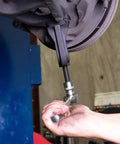 Heavy Duty Ball Joint Separator And Removal Tool Giving You Two Point Three Eighths Inch Extension For No Sweat Suspension Work On Daily Drivers Classic Rides Pickup Trucks SuVs in use removing a pivot point.