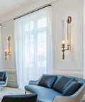 Gold Vintage Wall Sconce with Prismatic Clear Glass Tube (Metal Lamp Body) mounted beside elegant windows.