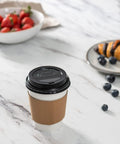 12 Oz Disposable Coffee Cups With Lids And Heat Resistant Sleeves, 100 Sets with breakfast on marble table