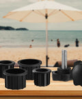 Six Piece Umbrella Base Replacement Parts Kit Includes Two 1.85 Inch Ring Plugs And Two 2 Inch Ring Plugs Plus M8 Thread Hand Knobs For Outdoor Patio Decks Backyards And Tables Black Must Have displayed on table with blurred beach background