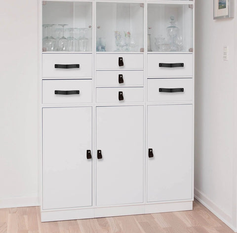 White cabinet with Black Leather Drawer Pulls 2 Piece Set Measuring 7 7/8 By 1 1/2 Inches Leather Handles installed on drawers.