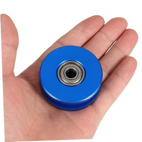 Aluminum Alloy U Groove Bearing Pulley For Cable Systems With Dual Bearings - Quiet, Smooth Roller For Gym Attachments, Heavy Duty Weight Training, High Efficiency, Stable And Durable Pro Grade Build. Blue aluminum alloy pulley with dual bearings in hand