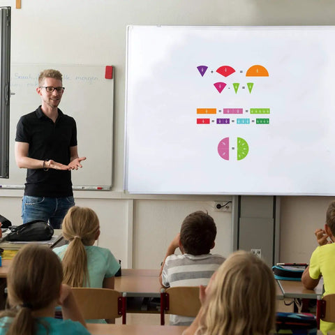 Teacher using Magnetic Fraction Tiles And Circles Set For Math Class And Home A Must Have 156-Piece Color Coded Fraction Set on whiteboard