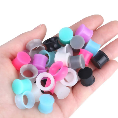Silicone Ear Plugs Gauge Stretching Kit for Ear Piercings and Lobe Stretchers, 32 Pieces, Sixteen Pairs in Mixed Colors in hand