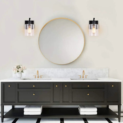 Bathroom with Dope Matte Black Wall Sconces Set of 2 Vanity Light Fixtures, bubble glass shades next to round mirror above black vanity.
