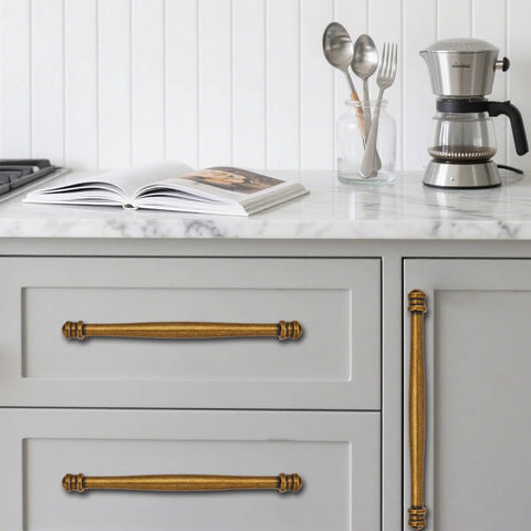 2 Pack 3-1/2 Inch Center to Center Antique Brass Cabinet Pulls installed on kitchen drawers, durable aluminum or stainless steel construction.