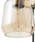 Close-up of smoked amber glass shade on Dope 1 Light Plug In Or Hardwire Wall Sconce In Matte Brass With Black Fabric Cord