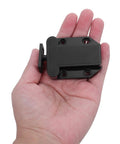 Hand holding a black Push To Open Cabinet Latch from 8 Pack Self Locking Drawer Catches for cabinets and doors with auto rebound mechanism