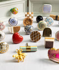 Assorted colorful ceramic dresser knobs displayed in various shapes and designs, highlighting the diverse style options.