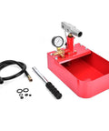 Manual hydraulic pressure test pump with gauge mounted on red base and included hose with fittings
