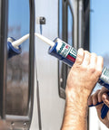 Person applying Pro Flex RV Flexible Sealant For Weatherproof Seals, 10 Oz Clear on RV seam with caulking tool