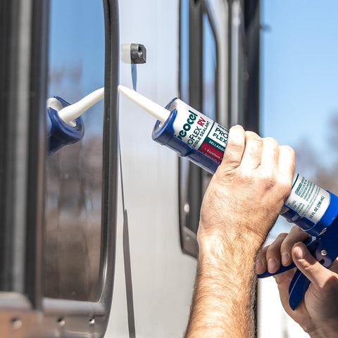 Person applying Pro Flex RV Flexible Sealant For Weatherproof Seals, 10 Oz Clear on RV seam with caulking tool