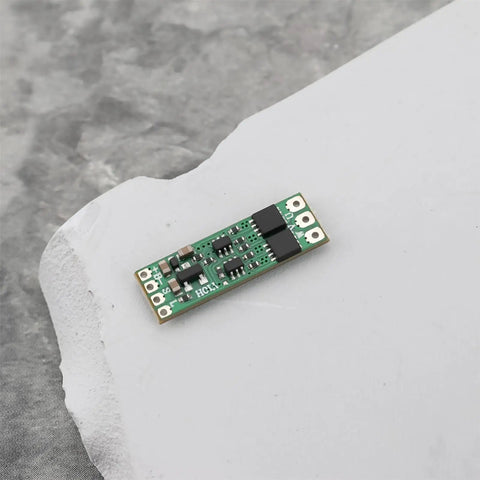 Close-up of Two Pack Micro Brushless ESC 8A Electronic Speed Controller Module For 1S To 3S Batteries on a gray surface.