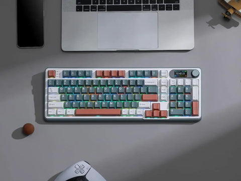 Slick Wireless Mechanical Keyboard With Integrated Smart Screen And Twist Knob For Rock Solid Triple Mode Connection And Total Fire Rgb Backlighting For Serious Gamers And Daily Hustlers Seeking A Clean Setup on a desk with laptop and accessories.