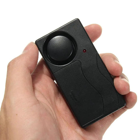 Hand holding Wireless Anti Theft Alarm With 110db Siren, Motion Sensor And Remote Control For Bikes, Motorcycles, Scooters, Doors, Windows And Any Vehicle Beef Up Your Ride Security On The Go