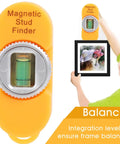 Portable Screw Finder Magnetic Detector for Wood and Metal Studs shown with a level, used for hanging frames.