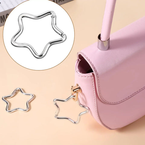 Two Pack Aluminum Star Shaped Carabiners With Key Rings attached to pink purse, small silver snap hooks for keys and wallets