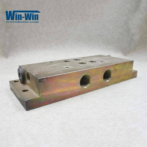 Waterjet hydraulic manifold block, top-mount, angled side view; metal with multiple threaded ports; Win-Win logo visible