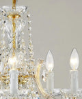 Close-up of Glam Crystal Chandelier In Gold Finish With 5 Lights, Maria Theresa Style K9 Crystals, crystal details and bulbs.