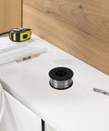 1KG Flux Core Welding Spool With Self-Shielding Metal Tin Wire For Precision Electronics Projects on a workspace.