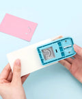 Person using Versatile Hangtag Punch For DIY Jewelry Displays And Card Tags, Corner Punch Tool For Keychains, on light paper