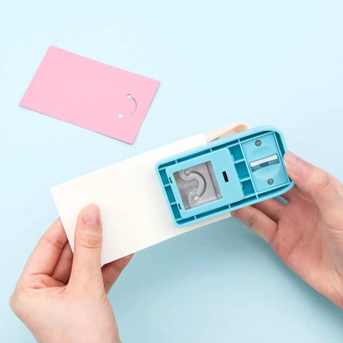 Person using Versatile Hangtag Punch For DIY Jewelry Displays And Card Tags, Corner Punch Tool For Keychains, on light paper