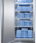Beefy Frost Free Upright All Freezer Delivering Solid Twenty Three Cubic Feet Chill Capacity Digital Thermostat Interface And Sleek Stainless Steel Build with blue ice packs inside.