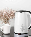 Heavy Duty 304 Stainless Steel Electric Kettle 1.7 Liter 1830 Watt Kicking Boils Fast cordless on table with white cup.